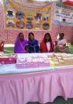 Women showcasing products at a rural entrepreneurship fair, highlighting local development and community empowerment initiatives.