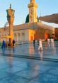 Pristine courtyard of a mosque at sunset, reflecting warm light with people in traditional attire strolling nearby.