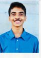 Smiling young man in a blue shirt, showcasing a friendly demeanor and youthful energy, perfect for professional profiles.