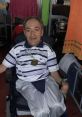 Oscar Jaraiz smiling while seated in a wheelchair, wearing a medal, representing resilience and determination.