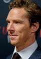 Benedict Cumberbatch at a premiere, showcasing his iconic curly hairstyle and sharp style, exuding charisma and charm.