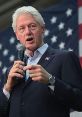 Bill Clinton speaks passionately at an event, emphasizing key messages against a backdrop of the American flag.