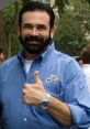 Billy Mays giving a thumbs up, wearing an OxiClean shirt, showcasing his signature charm and enthusiasm for cleaning products.