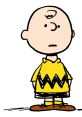 Charlie Brown stands thoughtfully in his iconic yellow zigzag shirt, embodying childhood innocence and introspection.