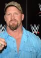 Stone Cold Steve Austin poses confidently, wearing a blue shirt and camo hat, showcasing his iconic wrestling persona.