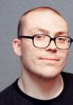 Anthony Fantano, music critic, smiling with glasses, showcasing his signature style and approach to music reviews.