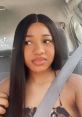 Maliya Cutrell showing stylish long hair while seated in a car, capturing a casual and fashionable vibe.