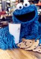 Cookie Monster enjoys cookies and milk at a cozy cafe, showcasing his iconic blue fur and cheerful expression.