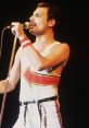 Freddie Mercury passionately performing on stage, wearing a unique outfit with an eye-catching arrow design.