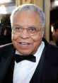 James Earl Jones smiling at a red carpet event, wearing a tuxedo and glasses, showcasing his iconic presence in film.