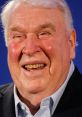 John Madden smiles warmly, showcasing his charisma and passion for football in a professional setting.