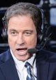 Kevin Harlan passionately commentates during a live sports broadcast, wearing a headset and microphone.