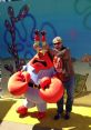 Mr. Krabs character poses playfully with Clancy Brown at a lively event, showcasing their fun interaction and vibrant backdrop.