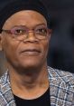 Samuel L. Jackson showcasing a stylish look with round glasses and a plaid jacket, exuding charisma and confidence.