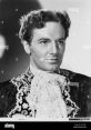 Classic portrait of John Sutton in an ornate costume, showcasing his distinct features and elegant style from the film era.