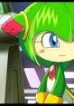 Cosmo, the green character with vibrant hair, showcases her playful personality in a colorful animated scene.