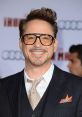 Robert Downey Jr. smiles at the Iron Man premiere, showcasing his stylish suit and signature glasses.