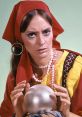 Mystical woman in vibrant attire gazes intently at a crystal ball, embodying the essence of a psychic seer.