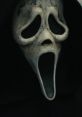 Iconic Ghostface mask from SCREAM (2022), featuring haunting eyes and an open mouth, embodying classic horror elements.