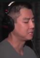 Van Darkholme focused on his craft, wearing headphones in a studio environment, showcasing his intense passion for creativity.