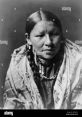 Portrait of a Native American woman adorned in traditional jewelry and clothing, highlighting cultural heritage and identity.