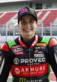 Ana Ribes Carrasco, smiling racer in racing gear, showcasing her passion for motorsports and motorcycle racing.