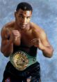 Mike Tyson poses confidently with his WBC championship belt, embodying strength and determination in boxing.