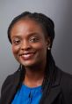 Professional headshot of Oluwatosin Fatunbi, featuring a smiling woman with braided hair, wearing a blue top and black blazer.