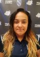 Erika Daniela Alvarado Cavero in a South Suburban College athletics polo, featuring the school's logo in the background.