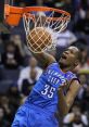 Kevin Durant performs a powerful dunk during a game, showcasing his athleticism and skill for the Oklahoma City Thunder.