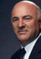 Kevin O'Leary, renowned entrepreneur and TV personality, poses in a formal suit, exuding confidence and charisma.