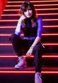 Liza Protskaya poses on illuminated stairs, showcasing her stylish outfit and vibrant personality at a trendy event.