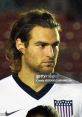 Profile of Zusi in a US soccer jersey, focused expression, showing dedication and passion for the game.