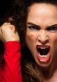 Angry woman with a fierce expression, shouting with clenched fists, showcasing intense emotion and frustration.