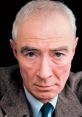 J. Robert Oppenheimer with piercing blue eyes, known as the father of the atomic bomb, portrayed in a thoughtful expression.