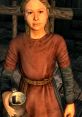 Female child character from Skyrim, wearing a brown dress, holding a metal mug, set in a rustic interior environment.