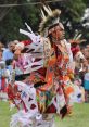 Traditional dancer in colorful regalia performing at a powwow, showcasing cultural heritage and vibrant community spirit.