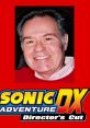 Deem Bristow, the voice of Dr. Eggman, smiles in a red sweater with Sonic Adventure DX logo in the background.