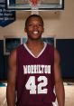 Alex McKey wearing jersey 42 for Morrilton basketball, smiling confidently in a gym setting, showcasing athletic talent.