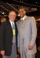 Brett Davidsen and another man posing together at a formal event, showcasing their stylish attire and cheerful expressions.