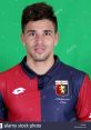 Geovanni wearing Genoa CFC jersey, smiling with green background, showcasing team spirit and player profile.