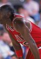 Michael Jordan catching his breath during a game, showcasing his athleticism and iconic Chicago Bulls uniform.