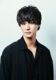 Stylish portrait of 富田翔太 with tousled hair and a black outfit, exuding a charismatic and confident aura.