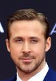 Ryan Gosling looking suave with a confident expression, showcasing his stylish hair and tailored suit at a red carpet event.