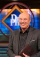 Dr. Phil smiles confidently in front of the show's backdrop, ready to engage with guests on important topics.