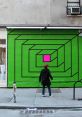 Vibrant green wall mural with geometric patterns and a pink square, capturing urban art's bold expression and creativity.