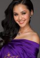 Lê Thu Trang smiles radiantly in a purple gown, showcasing her elegance and charm with beautiful accessories.