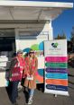 Becky Rowlands and a colleague promote health and wellbeing services at a Cheshire event, wearing bright vests.