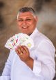 Joao Rosa smiling while holding a fan of tarot cards, showcasing his expertise in tarot reading and divination.