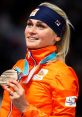 Irene Kraak proudly displays her medal, wearing the vibrant Team Netherlands jacket at the PyeongChang Olympics.